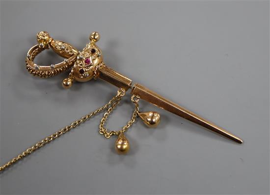 A yellow metal and gem set jabot? pin, modelled as a sword with scabbard, 71mm.